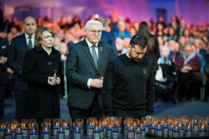 Überraschungsgast Wolodymyr Selenskyj, Präsident der Ukraine, der Bundespräsident und Frau Büdenbender beim Aufstellen von Kerzen nach der Zeremonie © Bundesregierung / Jesco Denzel